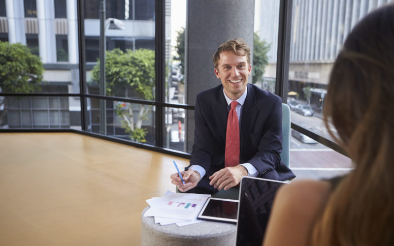 Young man offering CFO outsourcing services to client