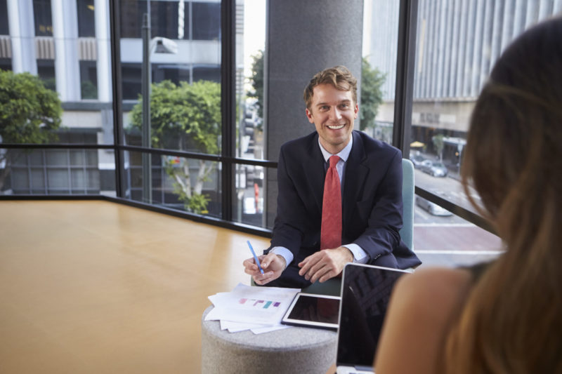 Young man offering CFO outsourcing services to client